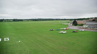 5.5K aerial stock footage of landing at an airport in Redhill, England Aerial Stock Footage | AX115_319