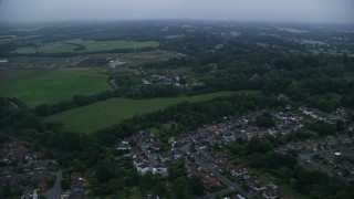 5.5K aerial stock footage of flying by homes in Redhill, England, twilight Aerial Stock Footage | AX116_002E