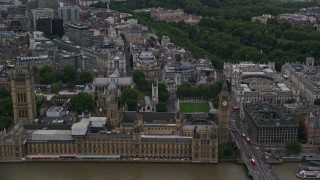 AX116_024E - 5.5K aerial stock footage approach British Parliament, Big Ben, and Westminster Abbey, London, England, twilight