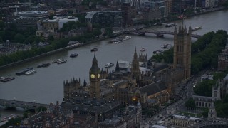 5.5K aerial stock footage of flying by Big Ben and British Parliament on River Thames, London, England, twilight Aerial Stock Footage | AX116_059E