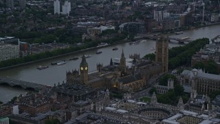 5.5K aerial stock footage of Big Ben and British Parliament beside River Thames, London, England, twilight Aerial Stock Footage | AX116_061E