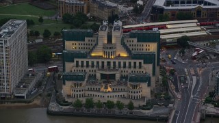 5.5K aerial stock footage of flying by MI6 Building by River Thames, London, England, twilight Aerial Stock Footage | AX116_065E