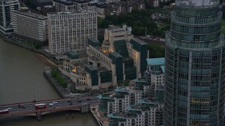 5.5K aerial stock footage of flying by MI6 Building and St George Wharf Tower, London, England, twilight Aerial Stock Footage | AX116_069