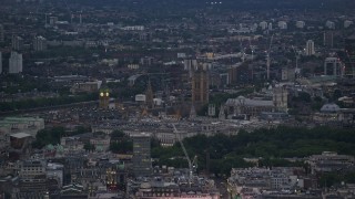 AX116_100 - 5.5K aerial stock footage of flying by Big Ben, Parliament, and Westminster Abbey in London, England, night