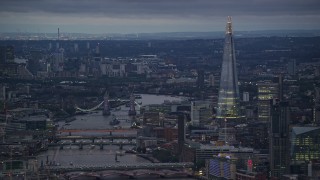 5.5K aerial stock footage of Tower Bridge spanning River Thames near The Shard, London, England, night Aerial Stock Footage | AX116_103E