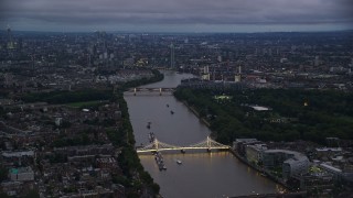 5.5K aerial stock footage of the London cityscape seen from Albert Bridge and River Thames, England, night Aerial Stock Footage | AX116_128E