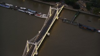 5.5K aerial stock footage of cars crossing Albert Bridge spanning River Thames, London, England, night Aerial Stock Footage | AX116_133E