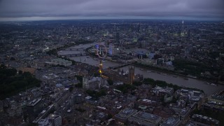 5.5K aerial stock footage approach Big Ben, British Parliament, London Eye, and River Thames, London, England, night Aerial Stock Footage | AX116_139E