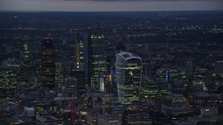 5.5K aerial stock footage of tall skyscrapers in Central London, England, night Aerial Stock Footage | AX116_151