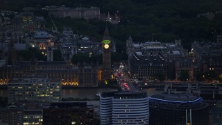 AX116_154 - 5.5K aerial stock footage of flying by famous Big Ben and British Parliament, London, England, night