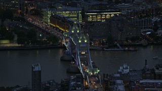 AX116_155E - 5.5K aerial stock footage of orbiting Tower Bridge spanning River Thames, London, England, night