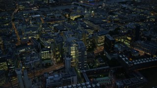 5.5K aerial stock footage of panning across Central London office buildings, England, night Aerial Stock Footage | AX116_172