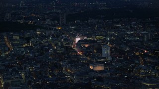 5.5K aerial stock footage of flying over city buildings to approach Piccadilly Circus, London, England, night Aerial Stock Footage | AX116_176