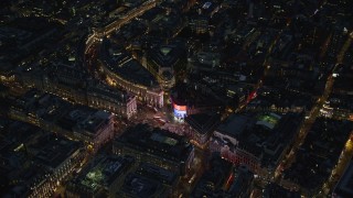 AX116_186 - 5.5K aerial stock footage of circling above Piccadilly Circus and city buildings, London, England, night