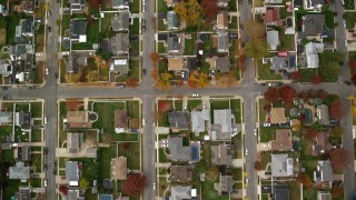 AX117_010E - 5.5K aerial stock footage of a bird's eye view of suburban neighborhood in Autumn, Massapequa, New York