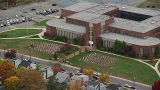 5.5K aerial stock footage of a flag display at high school in Autumn, Merrick, New York Aerial Stock Footage | AX117_038E