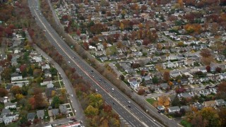 5.5K aerial stock footage of light traffic on freeway in Autumn, Seaford, New York Aerial Stock Footage | AX117_050E