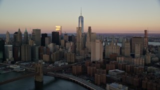 5.5K aerial stock footage of a view of Lower Manhattan's skyscrapers at sunrise in New York City Aerial Stock Footage | AX118_071E