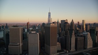 5.5K aerial stock footage of flying by Lower Manhattan skyscrapers at sunrise in New York City Aerial Stock Footage | AX118_076E