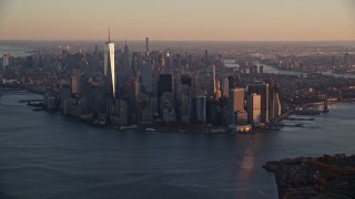 AX118_083 - 5.5K aerial stock footage of a slow approach to Lower Manhattan at sunrise, New York City