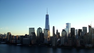 5.5K aerial stock footage of approaching the World Trade Center skyline at sunrise in New York City Aerial Stock Footage | AX118_152E