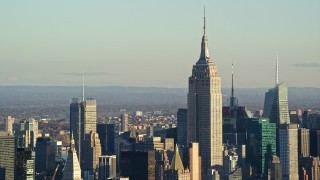 5.5K aerial stock footage of the Empire State Building towering over Midtown at sunrise in New York City Aerial Stock Footage | AX118_173E