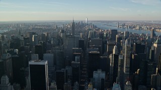 5.5K aerial stock footage of Midtown skyscrapers at sunrise in New York City, with view of distant Lower Manhattan Aerial Stock Footage | AX118_197E