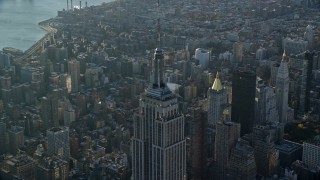 5.5K aerial stock footage of orbiting the top of the Empire State Building at sunrise in New York City Aerial Stock Footage | AX118_204