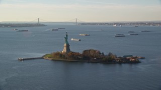 5.5K aerial stock footage of an orbit of Statue of Liberty at sunrise in New York Aerial Stock Footage | AX118_216E