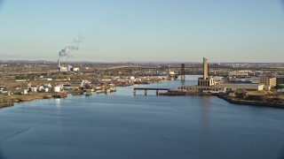 5.5K aerial stock footage of riverfront factories and bridges at sunrise in Kearny and Newark, New Jersey Aerial Stock Footage | AX118_226