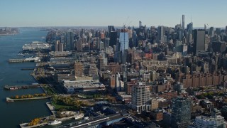 AX119_024 - 5.5K aerial stock footage of piers and riverfront buildings in Chelsea and skyscrapers in Midtown, New York City