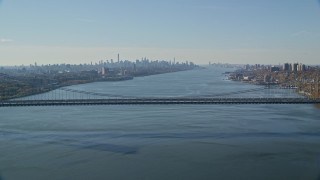 AX119_047E - 5.5K aerial stock footage of George Washington Bridge and Midtown skyline in Autumn, New York City