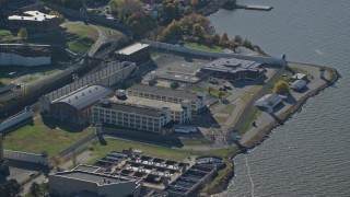 5.5K aerial stock footage of orbiting riverfront Sing Sing Prison in Autumn, Ossining, New York Aerial Stock Footage | AX119_118E