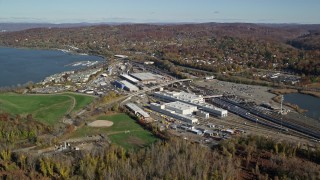 5.5K aerial stock footage of a riverfront rail station in Autumn, Croton on Hudson, New York Aerial Stock Footage | AX119_127E