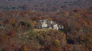 5.5K aerial stock footage orbit an isolated hilltop mansion in Autumn, Croton on Hudson, New York Aerial Stock Footage | AX119_134