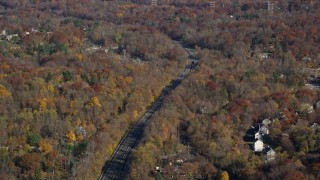 5.5K aerial stock footage of a tree-lined highway in Autumn, Croton on Hudson, New York Aerial Stock Footage | AX119_135