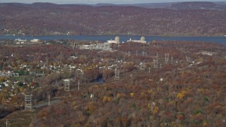 AX119_140E - 5.5K aerial stock footage of a view of Indian Point Nuclear Power Plant in Autumn, Buchanan, New York