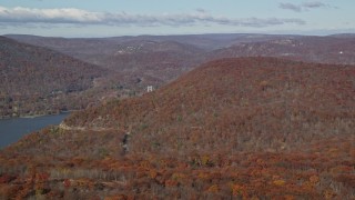 5.5K aerial stock footage of flying by forest in Autumn by the Hudson River, Westchester County, New York Aerial Stock Footage | AX119_150