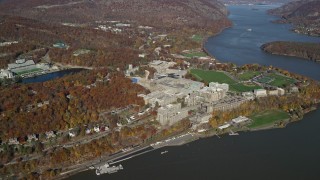 5.5K aerial stock footage of a wide orbit around West Point Military Academy in Autumn, West Point, New York Aerial Stock Footage | AX119_180E