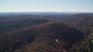 5.5K aerial stock footage approaching hills with forests in Autumn, Garrison, New York Aerial Stock Footage | AX119_185E