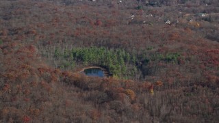 5.5K aerial stock footage of a pond and forest in Autumn, Garrison, New York Aerial Stock Footage | AX119_192E