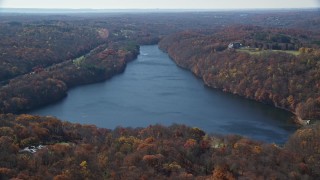 AX119_215 - 5.5K aerial stock footage orbit reservoir in Autumn, Mt Kisco, New York