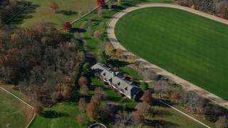 AX119_222E - 5.5K aerial stock footage of orbiting a race track in Autumn, Greenwich, Connecticut