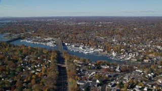 AX119_232 - 5.5K aerial stock footage of a small town marina and neighborhood in Autumn, Greenwich, Connecticut