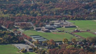 5.5K aerial stock footage of a small time high school in Autumn, Syosset, New York Aerial Stock Footage | AX119_246