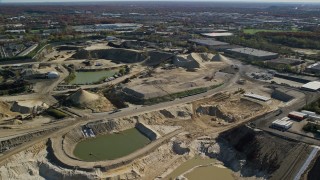 AX119_253 - 5.5K aerial stock footage of orbiting a construction site in Autumn, Melville, New York