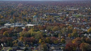 5.5K aerial stock footage of a suburban residential neighborhood and water tower in Autumn, Farmingdale, New York Aerial Stock Footage | AX119_254