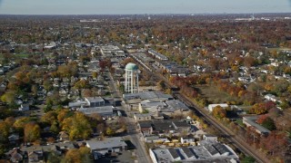 AX119_255 - 5.5K aerial stock footage orbit industrial buildings and train tracks in Autumn, Farmingdale, New York