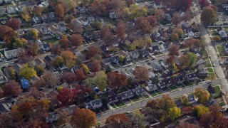 5.5K aerial stock footage of rows of suburban homes in Autumn, Uniondale, New York Aerial Stock Footage | AX120_025E