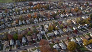 AX120_029E - 5.5K aerial stock footage of flying over a quiet suburban neighborhood in Autumn, Hempstead, New York